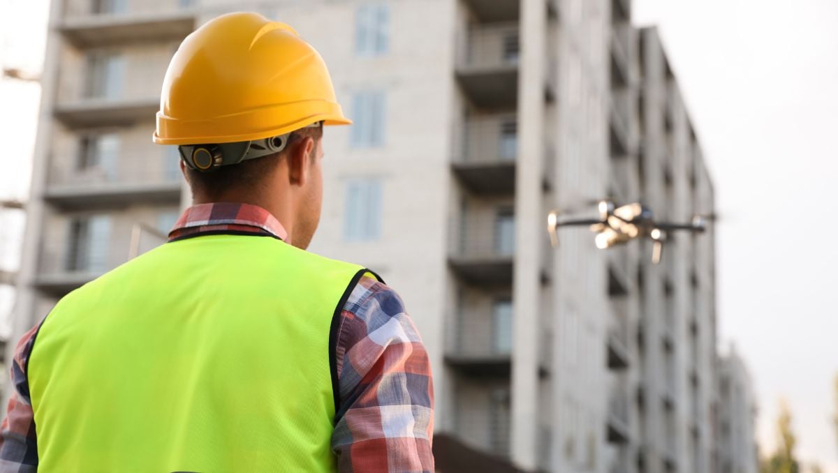 This image depicts an AI-powered drone being used to inspect a building for early detection of wear and damage.